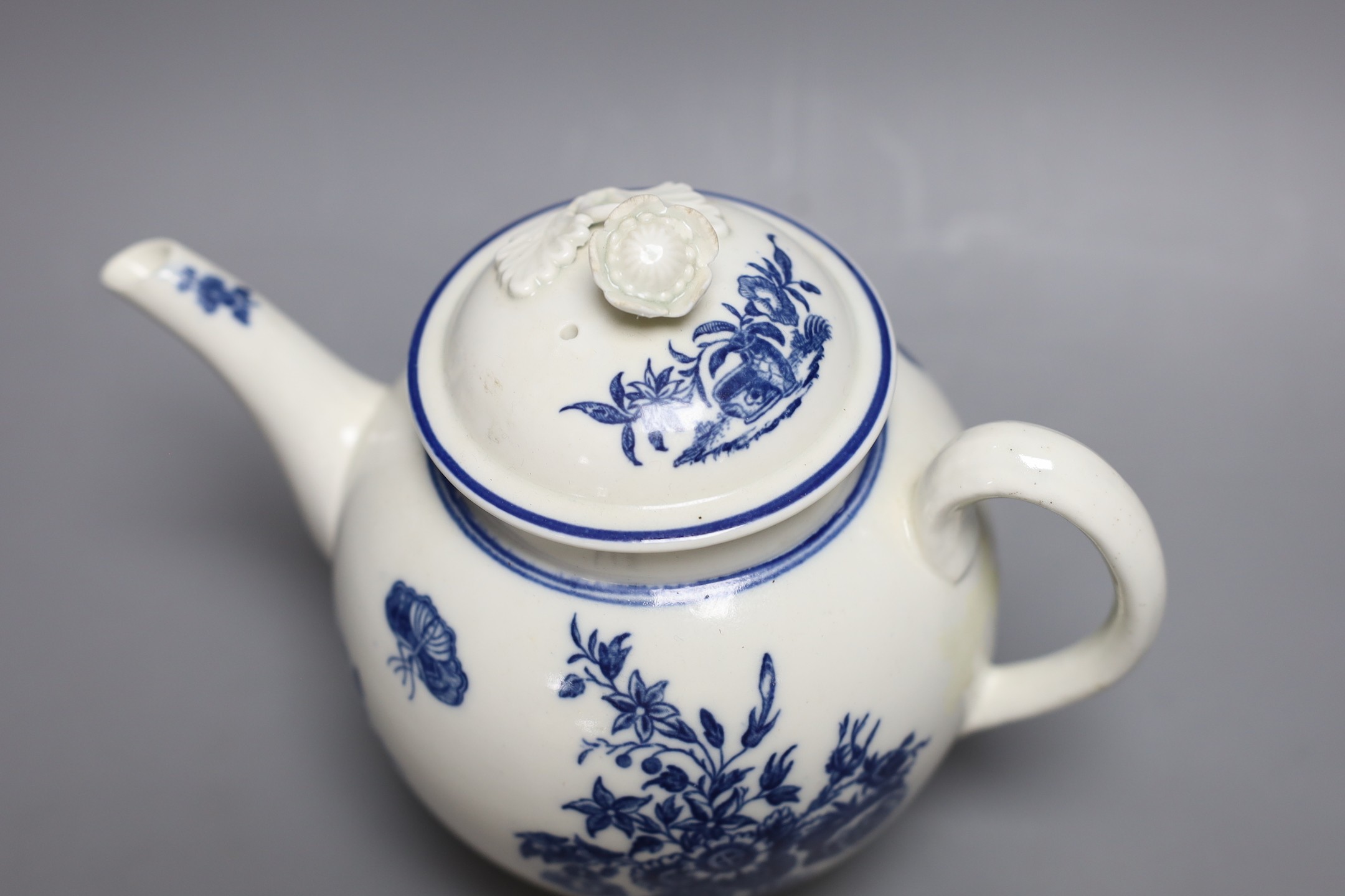 A Caughley teapot and cover printed in underglaze blue with the Three Flowers pattern, S mark in blue to base, 17 cms high